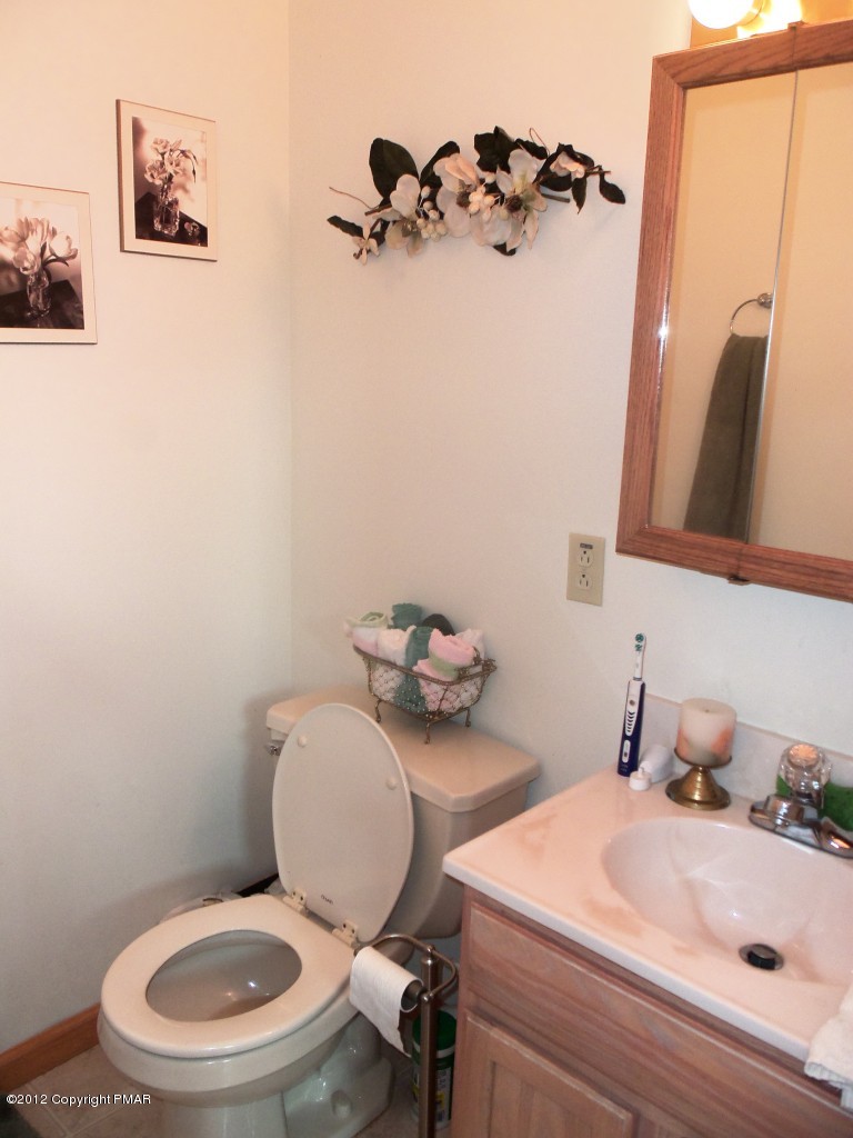 116 Granite Road Long Pond, PA 18334 - Photo 8 of 28 a bathroom with a toilet sink and mirror