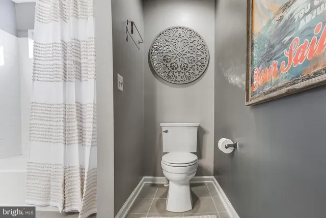 a view of a hallway to a livingroom with furniture and stairs