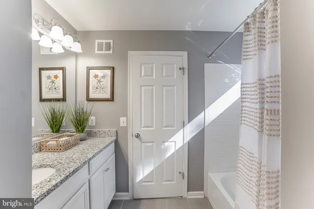 a bathroom with a tub and shower