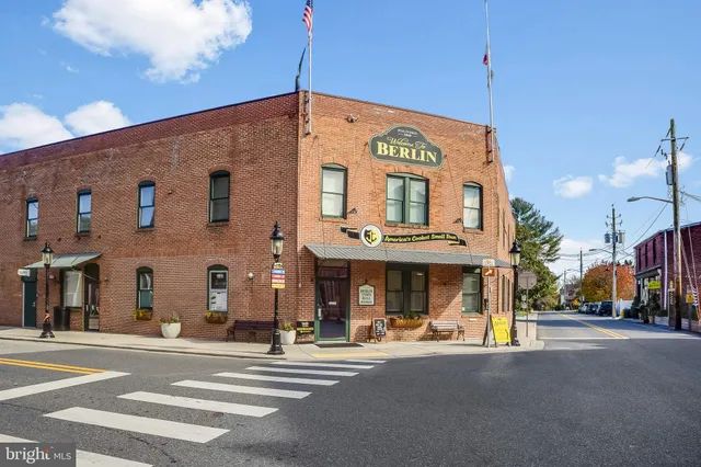a front view of multi story building with retail shops