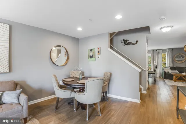 a view of a dining room with furniture and wooden floor