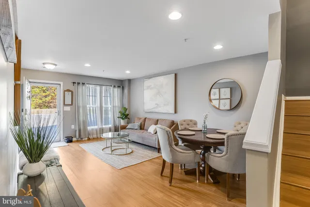 a living room with furniture a window and a potted plant