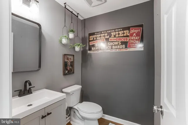 a bathroom with a toilet sink and mirror