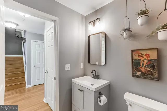 a bathroom with a toilet a sink and mirror