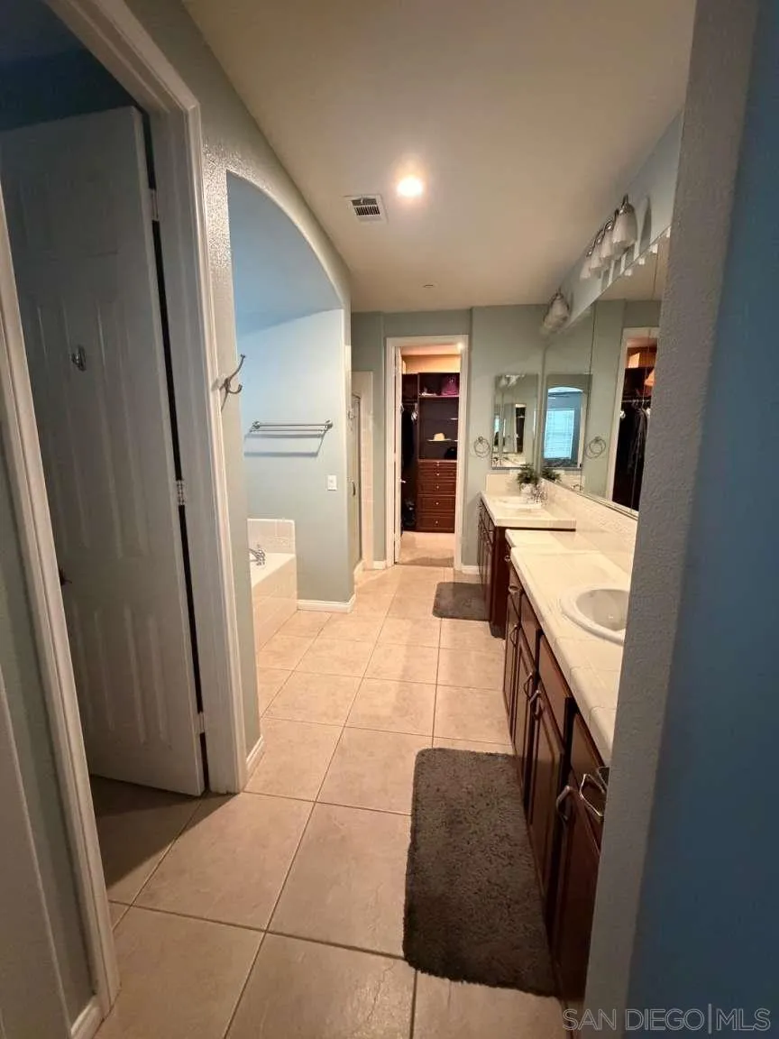 2327 Clearcrest Lane Fallbrook, CA 92028 - Photo 12 of 28 a large white kitchen with a sink a refrigerator and a stove