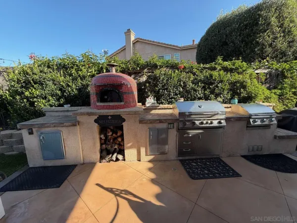 a kitchen with kitchen island granite countertop wooden cabinets a sink and a stove