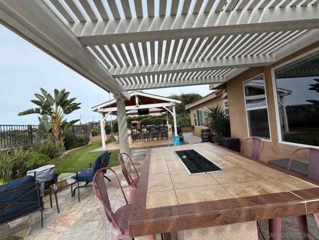 a view of a porch with furniture and yard