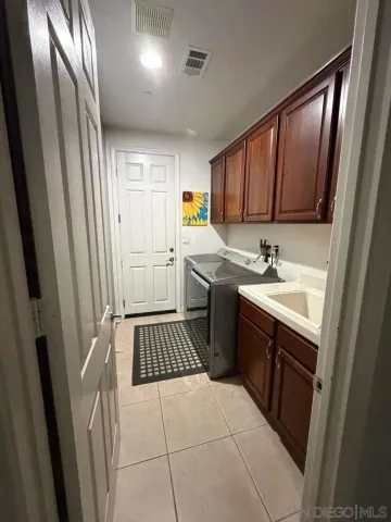 a kitchen with a sink refrigerator and cabinets