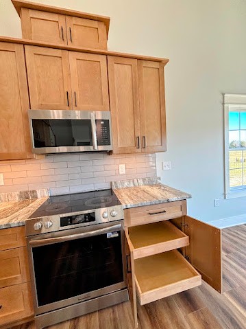 8184 Aedc Road Estill Springs, TN 37330 - Photo 18 of 43 a kitchen with stainless steel appliances granite countertop a stove and a microwave