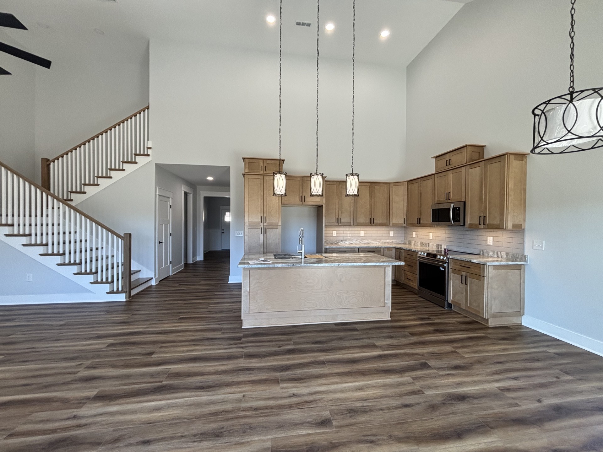 8184 Aedc Road Estill Springs, TN 37330 - Photo 24 of 43 a large kitchen with stainless steel appliances kitchen island granite countertop a stove a sink and white cabinets