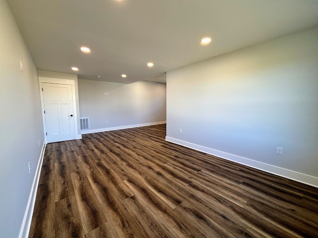 8184 Aedc Road Estill Springs, TN 37330 - Photo 41 of 43 an empty room with wooden floor