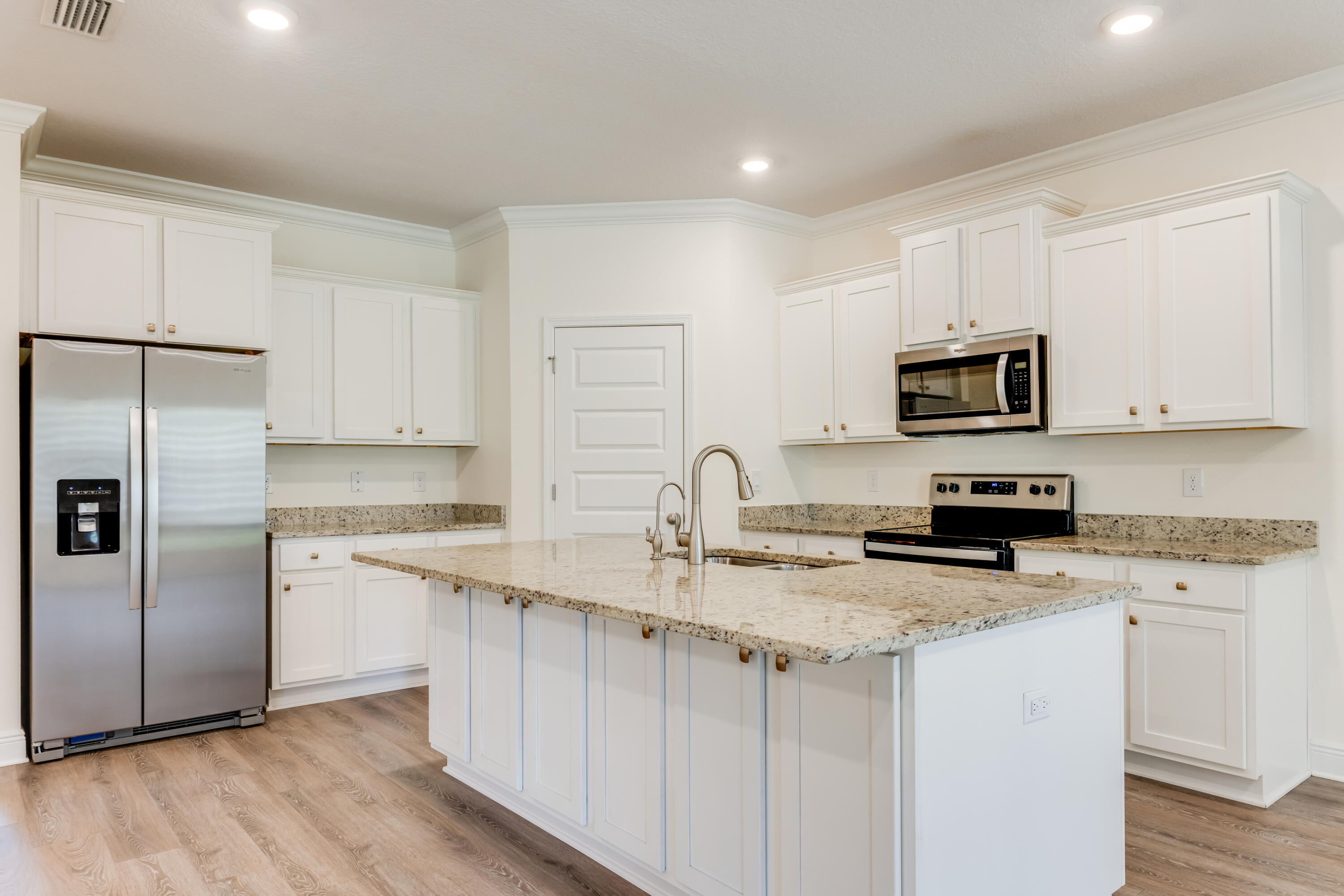 121 Lightning Bug Lane Freeport, FL 32439 - Photo 11 of 53 a kitchen with stainless steel appliances granite countertop a sink stove microwave and refrigerator