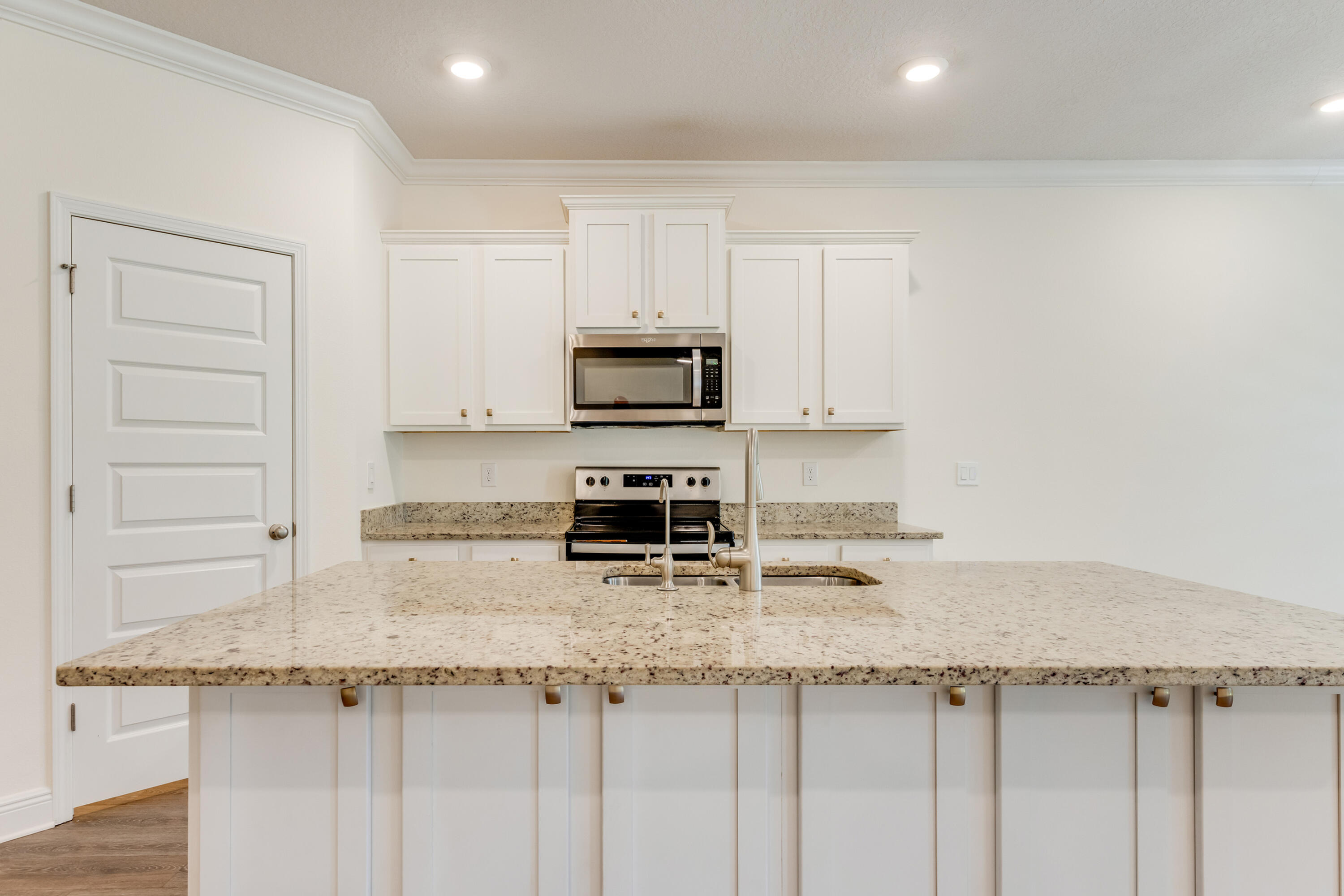 121 Lightning Bug Lane Freeport, FL 32439 - Photo 12 of 53 a kitchen with granite countertop a sink a stove and cabinets