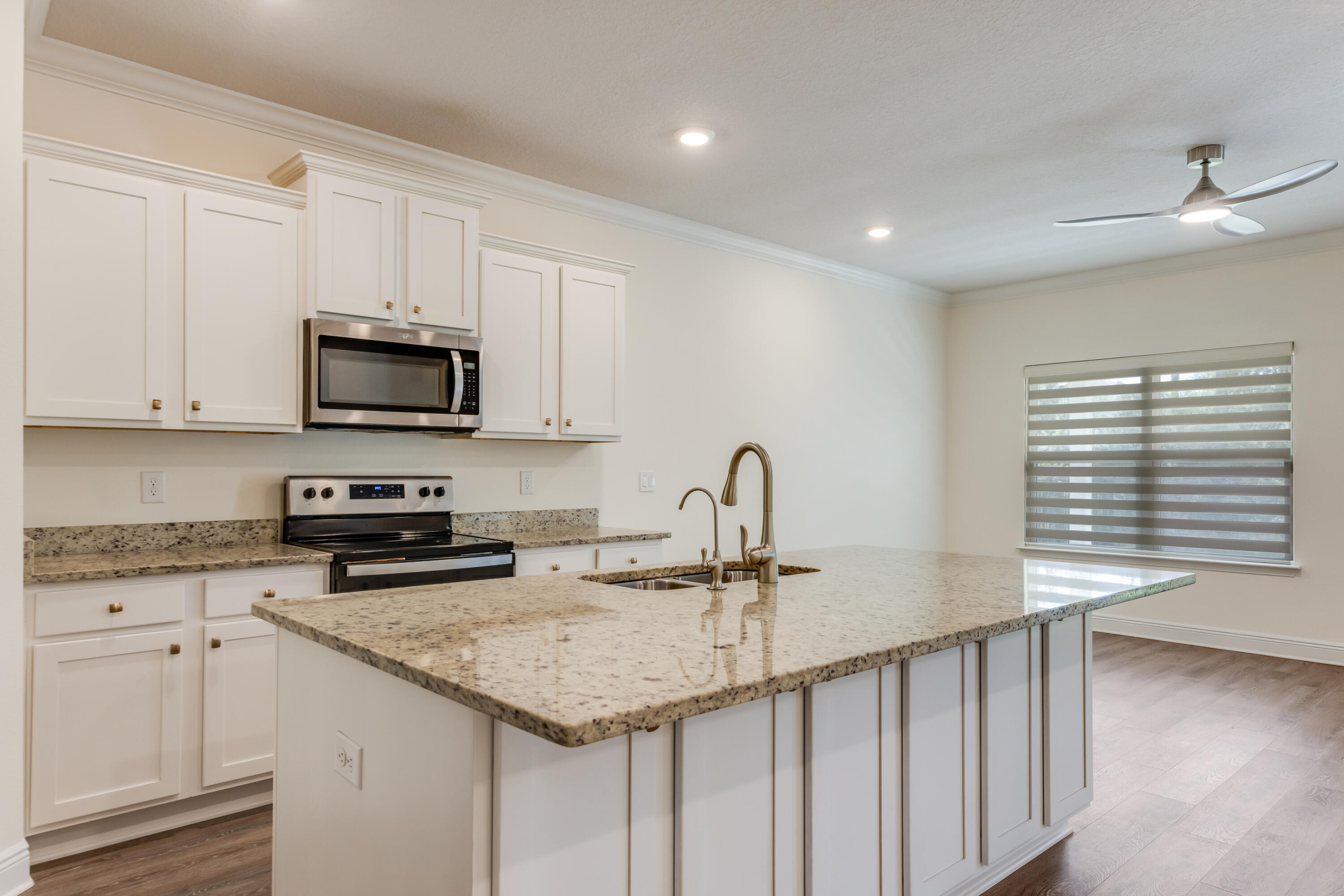 121 Lightning Bug Lane Freeport, FL 32439 - Photo 13 of 53 a kitchen with stainless steel appliances granite countertop a sink a stove and cabinets