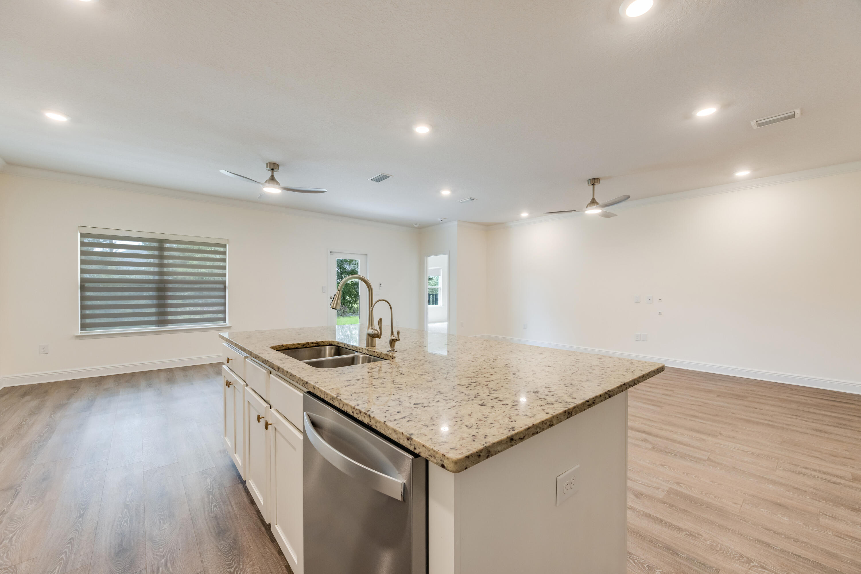 121 Lightning Bug Lane Freeport, FL 32439 - Photo 15 of 53 a kitchen with stainless steel appliances granite countertop a sink and a wooden floor