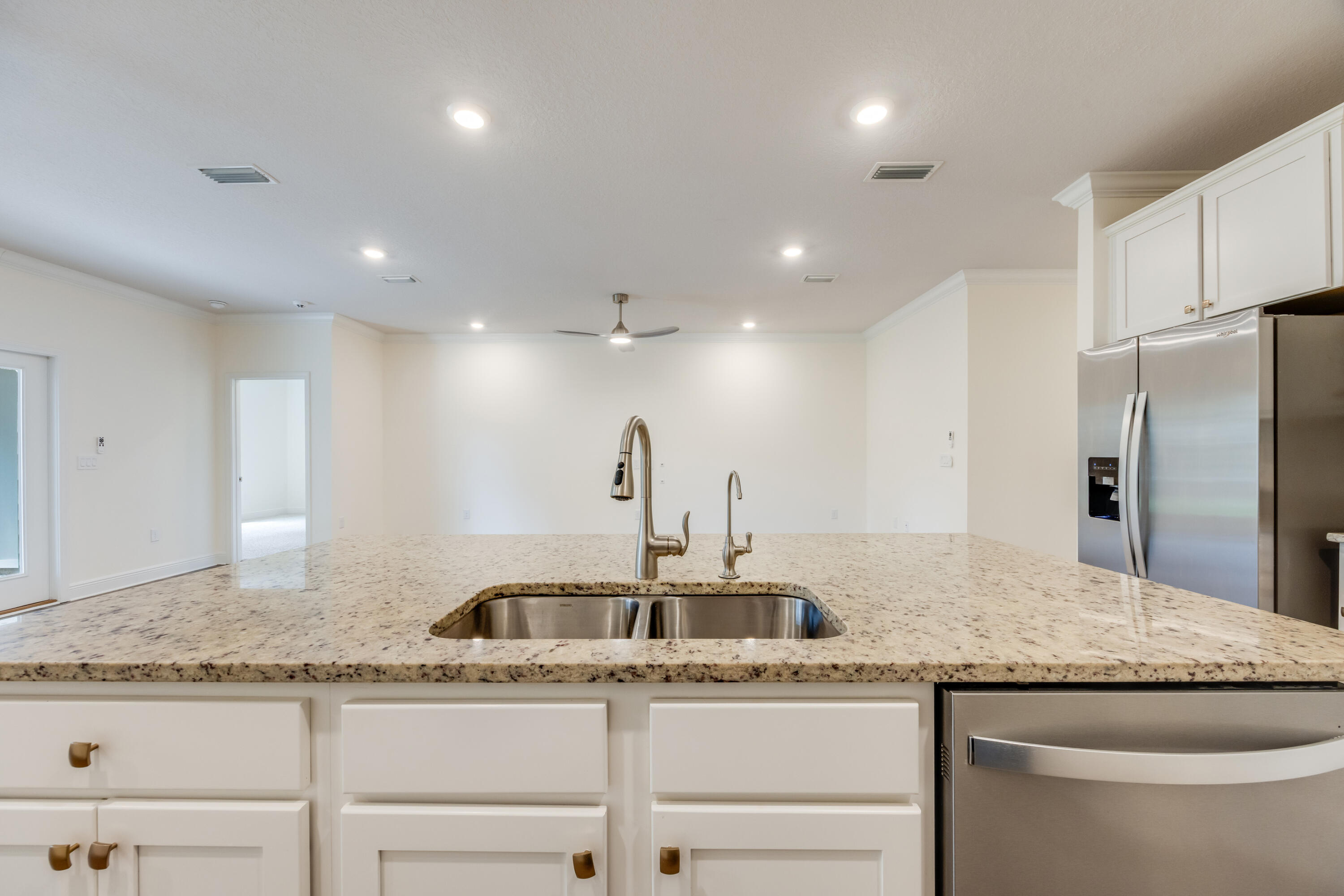 121 Lightning Bug Lane Freeport, FL 32439 - Photo 16 of 53 a kitchen with granite countertop a sink and refrigerator