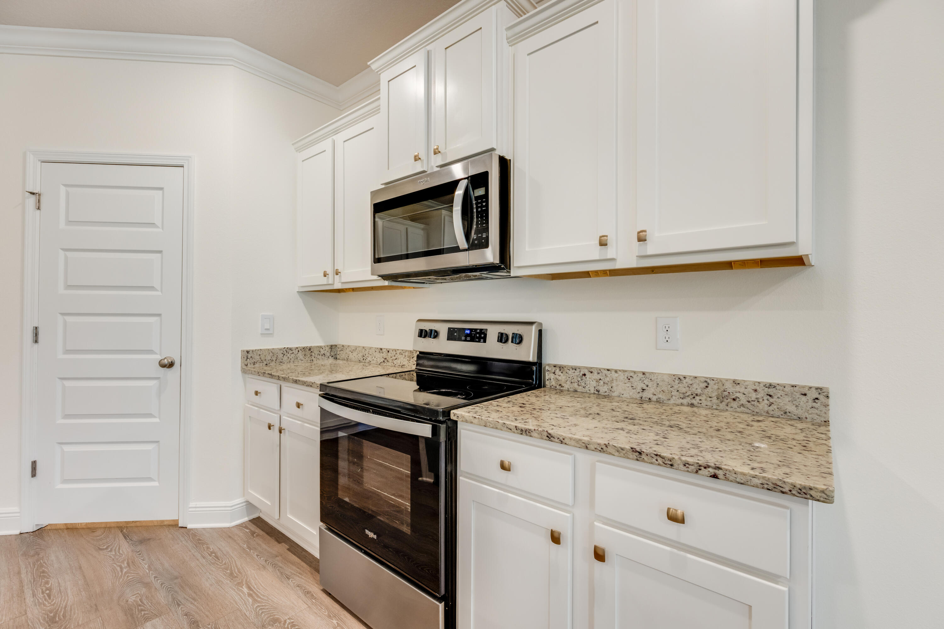 121 Lightning Bug Lane Freeport, FL 32439 - Photo 18 of 53 a kitchen with granite countertop cabinets stainless steel appliances and wooden floor