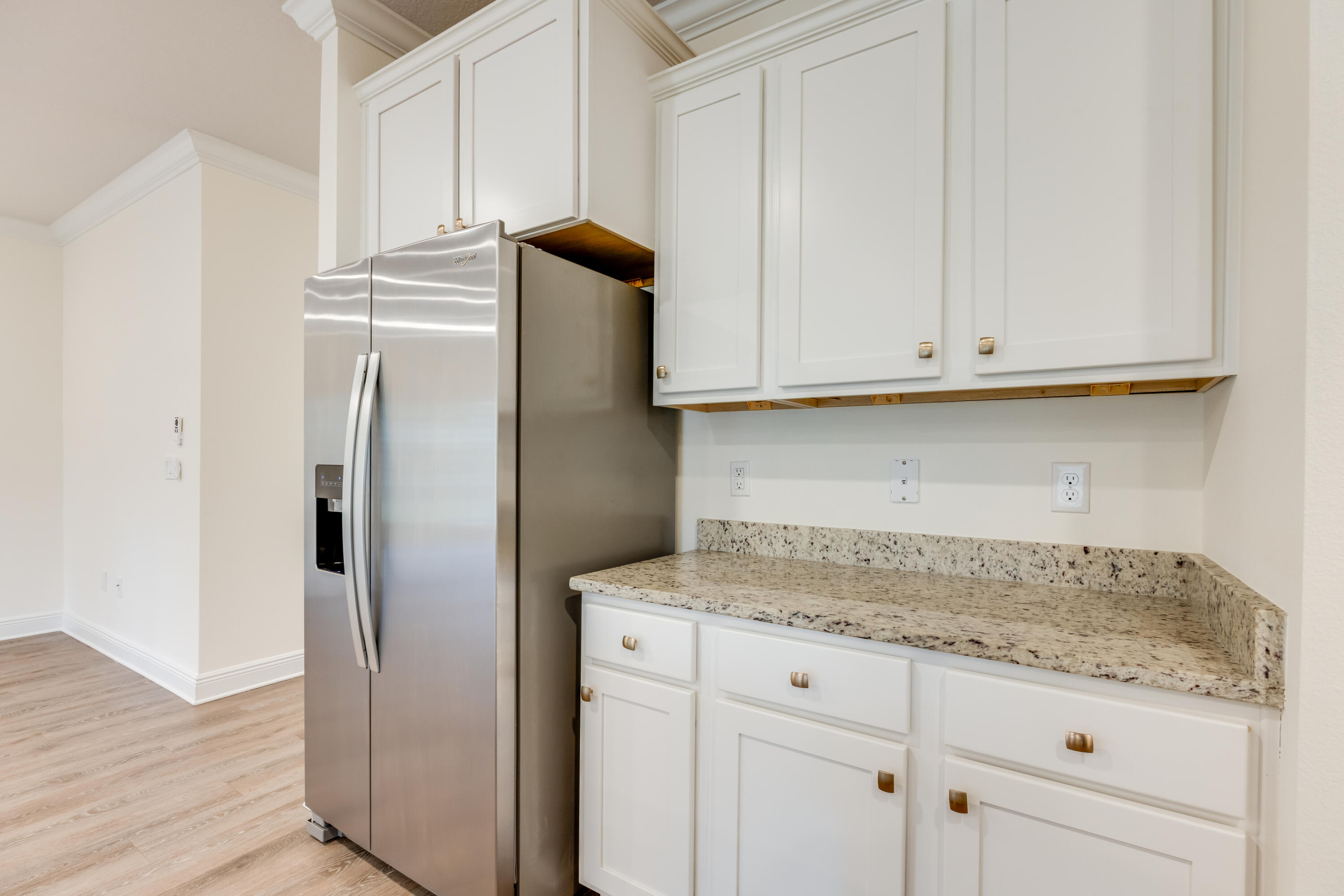 121 Lightning Bug Lane Freeport, FL 32439 - Photo 19 of 53 a kitchen with granite countertop white cabinets and a refrigerator