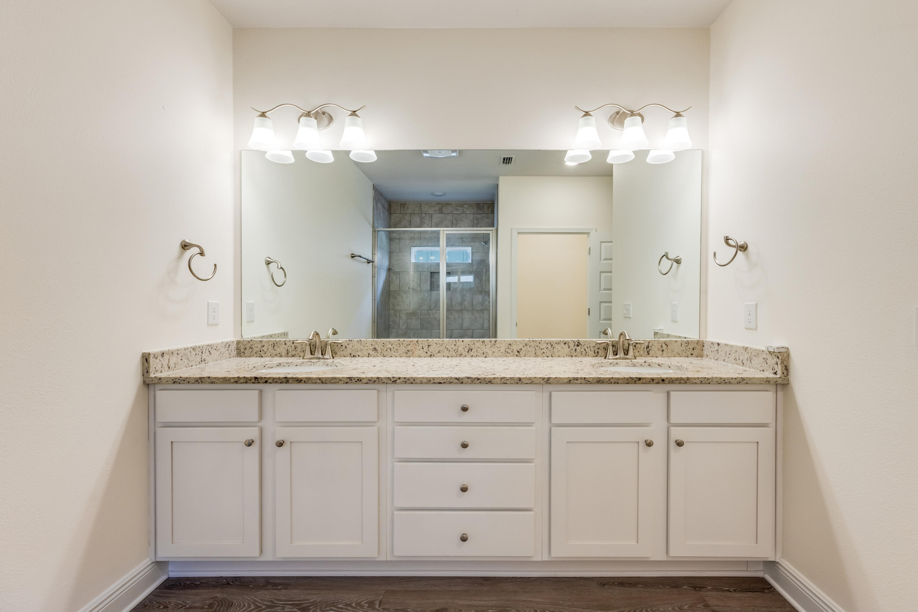 121 Lightning Bug Lane Freeport, FL 32439 - Photo 24 of 53 a bathroom with a granite countertop double vanity sink a mirror and shower