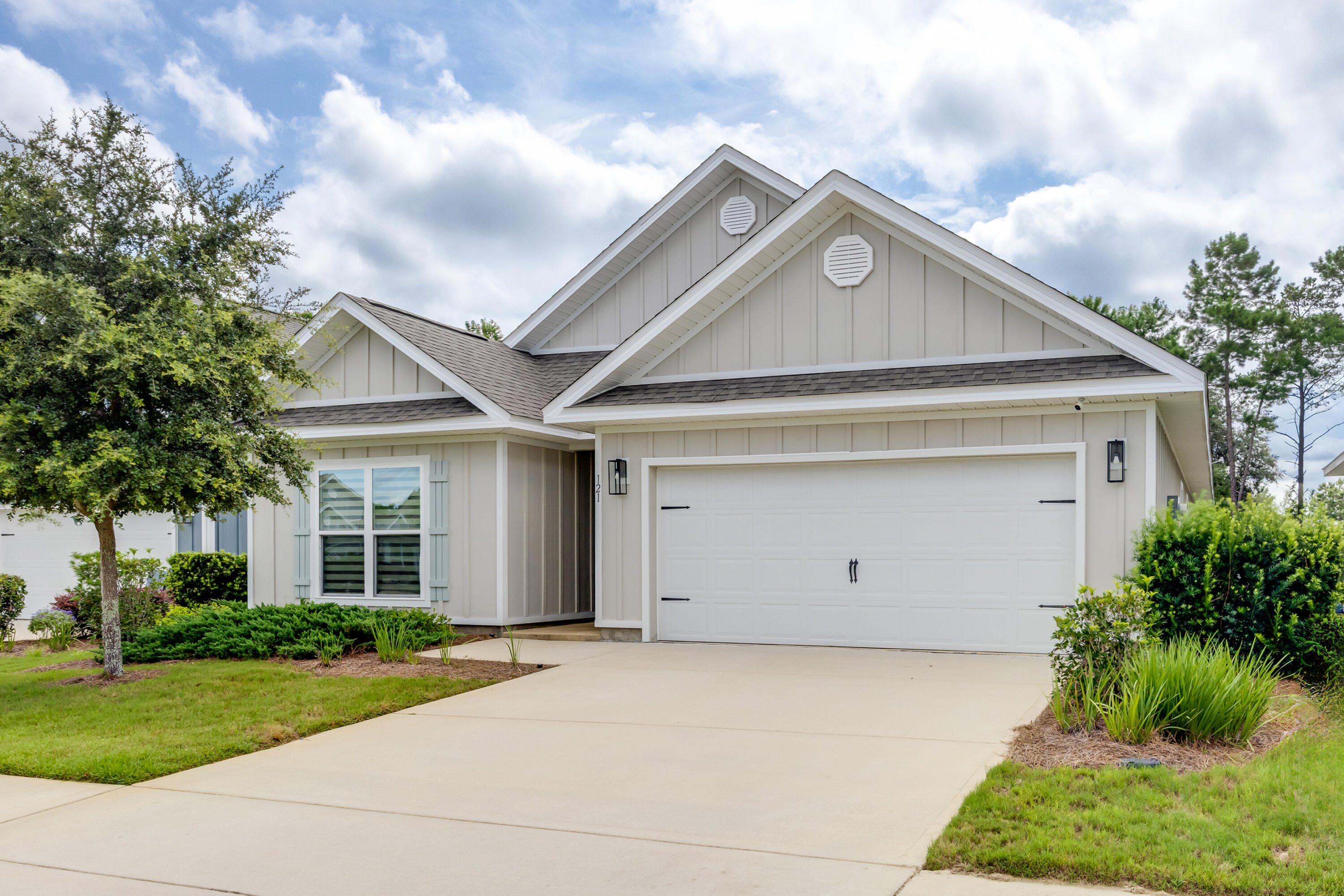 121 Lightning Bug Lane Freeport, FL 32439 - Photo 3 of 53 a view of house with garden and garage