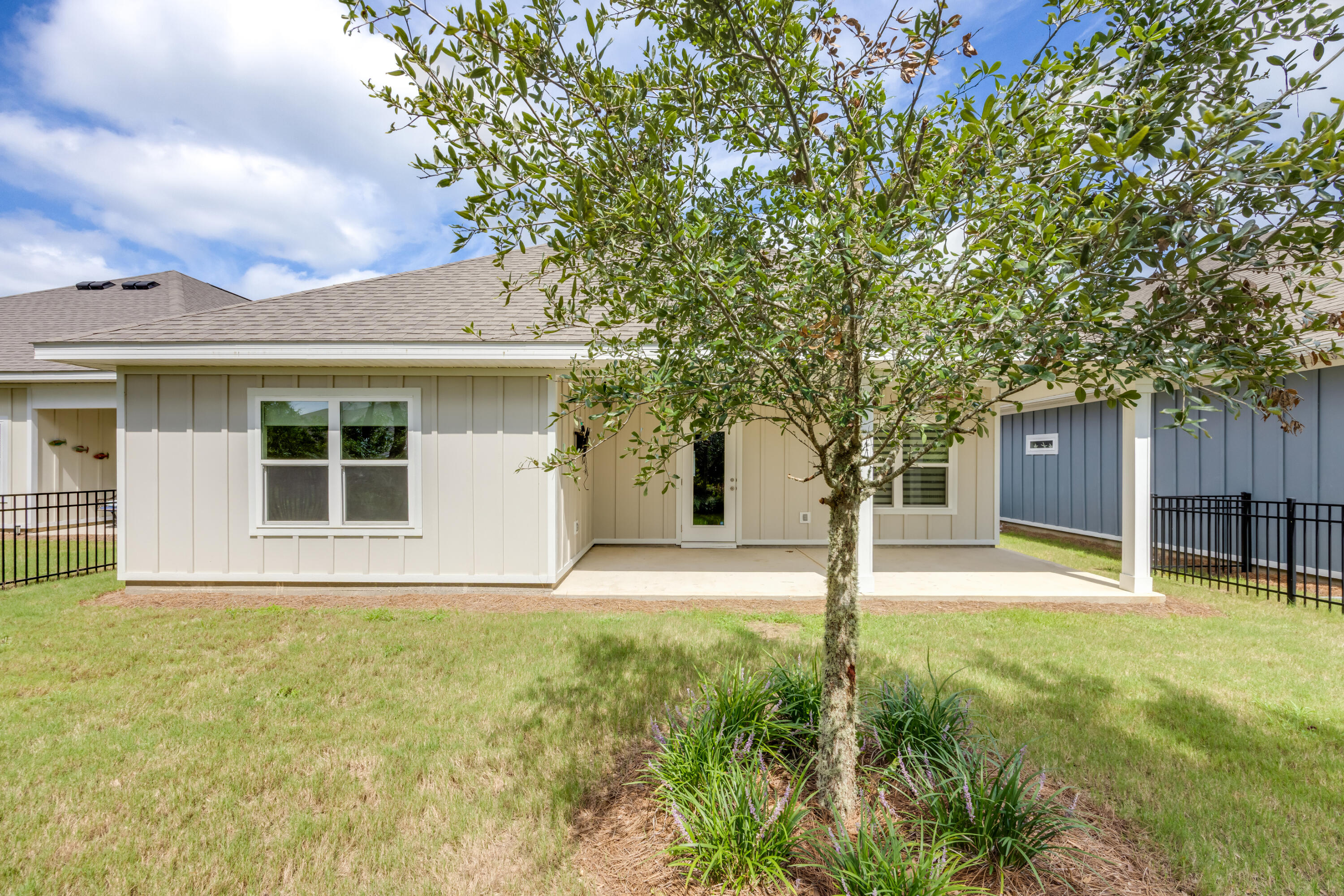121 Lightning Bug Lane Freeport, FL 32439 - Photo 39 of 53 a house with trees in the background