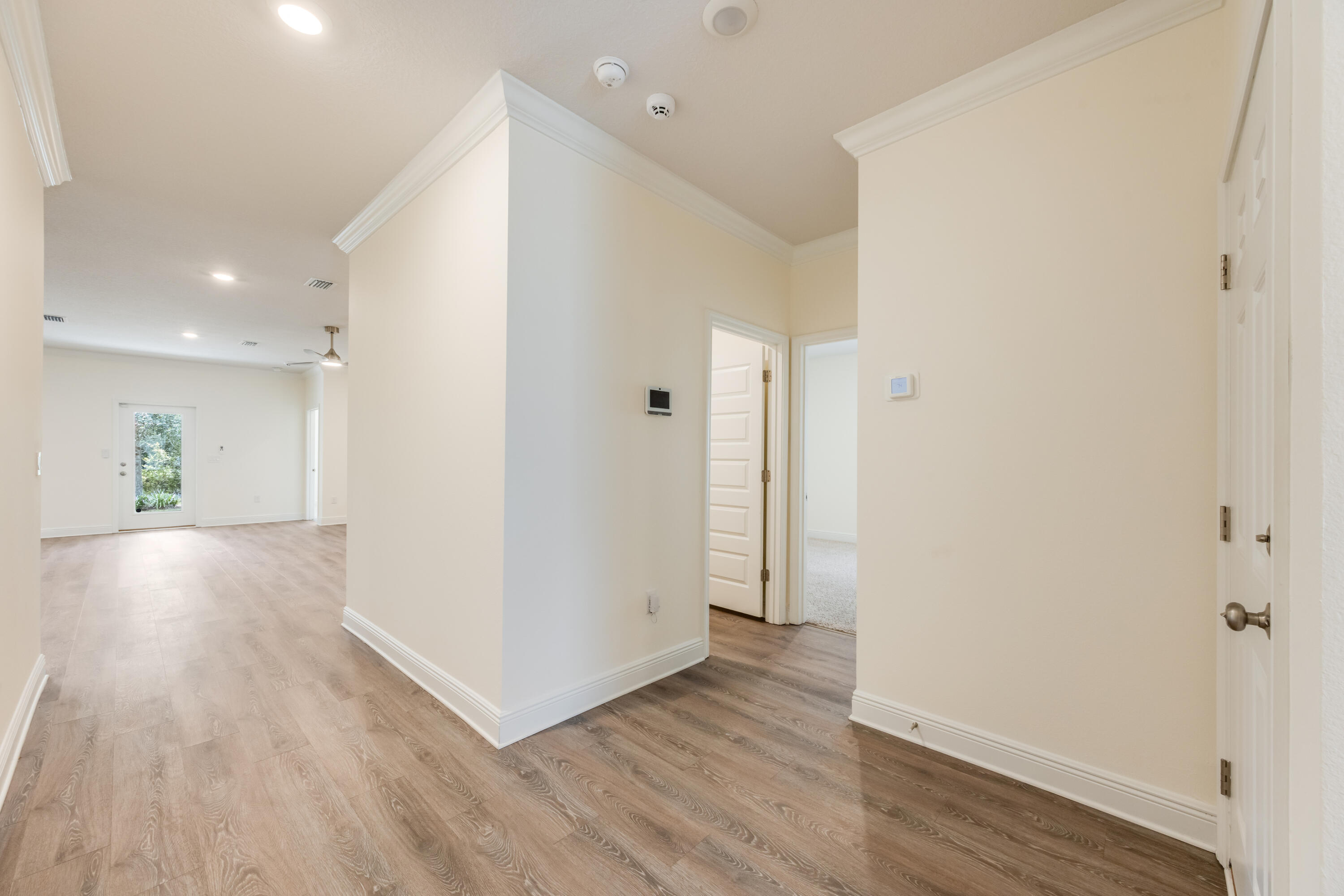 121 Lightning Bug Lane Freeport, FL 32439 - Photo 5 of 53 a view of a hallway with wooden floor