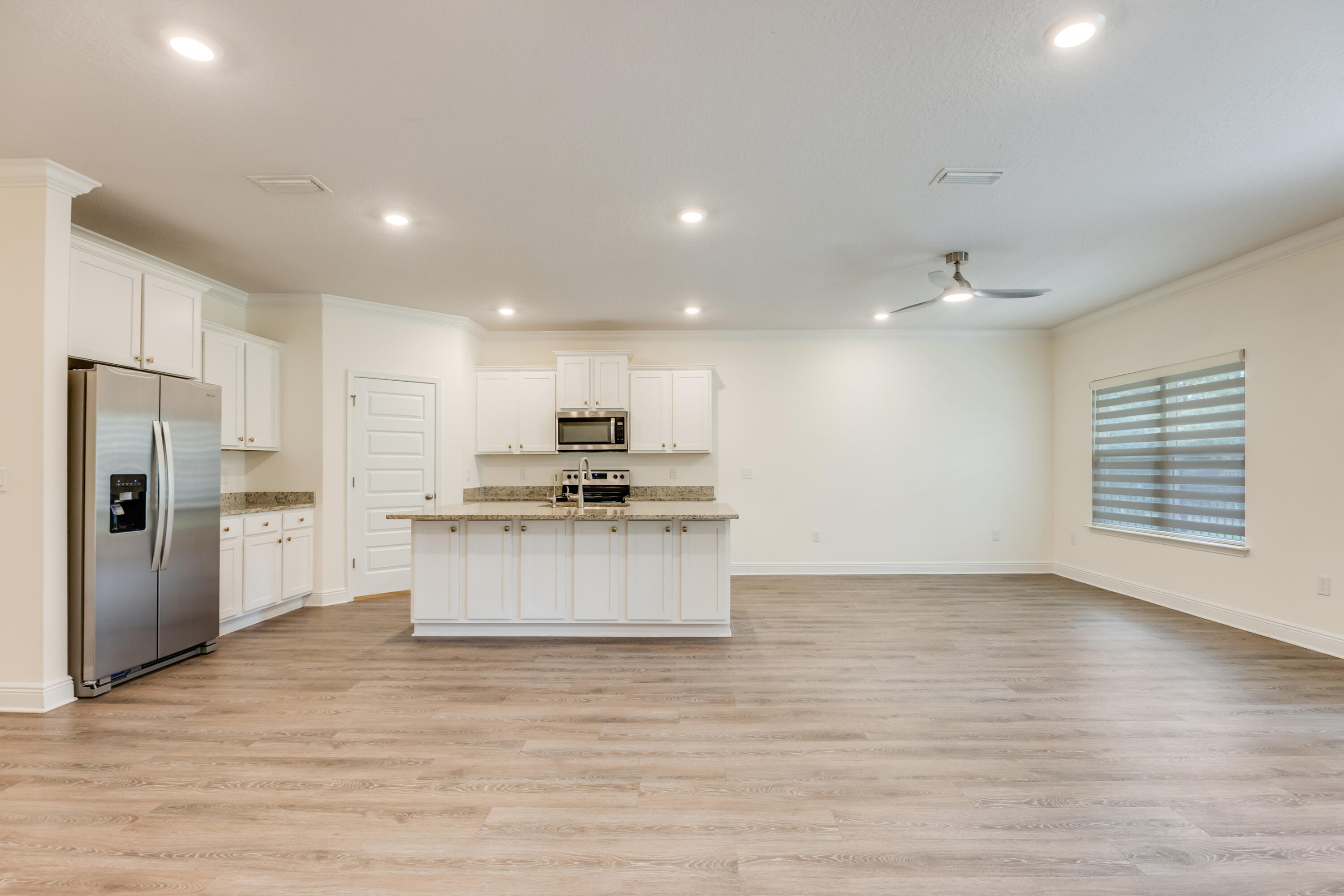 121 Lightning Bug Lane Freeport, FL 32439 - Photo 8 of 53 a large kitchen with stainless steel appliances a large counter top a stove and a refrigerator