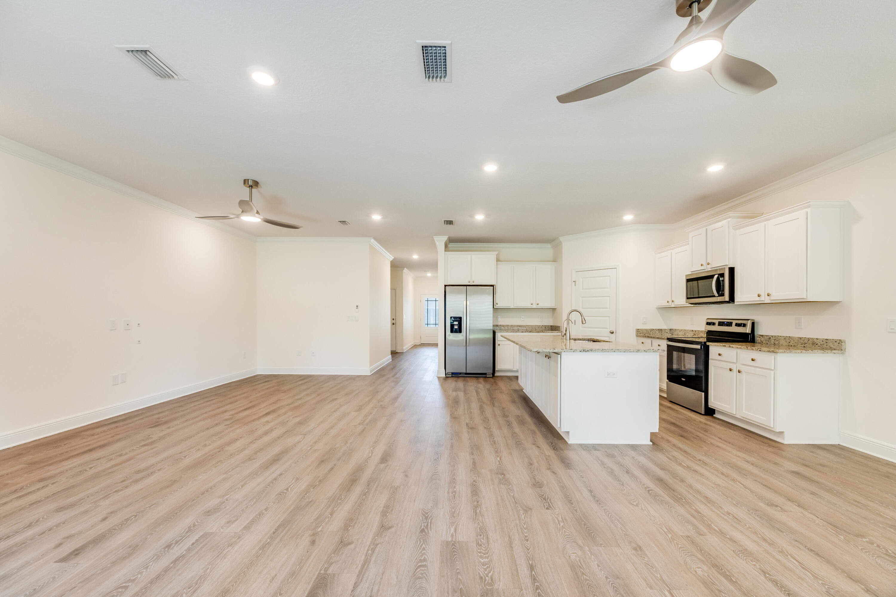 121 Lightning Bug Lane Freeport, FL 32439 - Photo 10 of 53 a view of kitchen with cabinets microwave and stove
