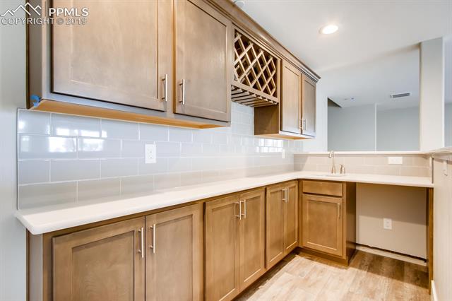 5335 Old Star Ranch View Colorado Springs, CO 80906 - Photo 11 of 13 Full wet bar in basement to entertain with walkout patio