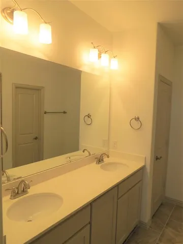 a bathroom with a glass shower door