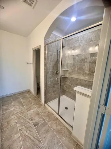 an empty room with closet and a chandelier fan