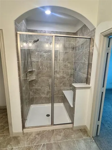 a bathroom with a glass shower door