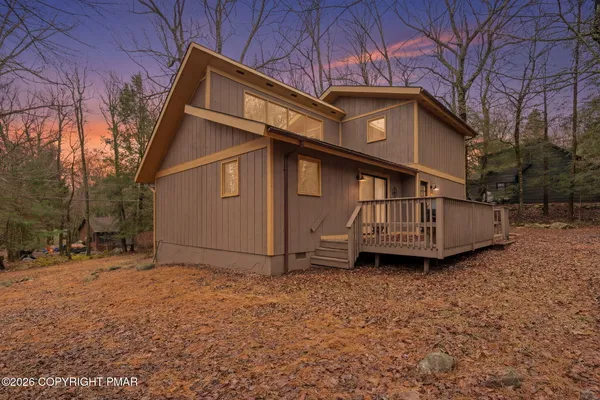 a view of a house with a yard and sitting area