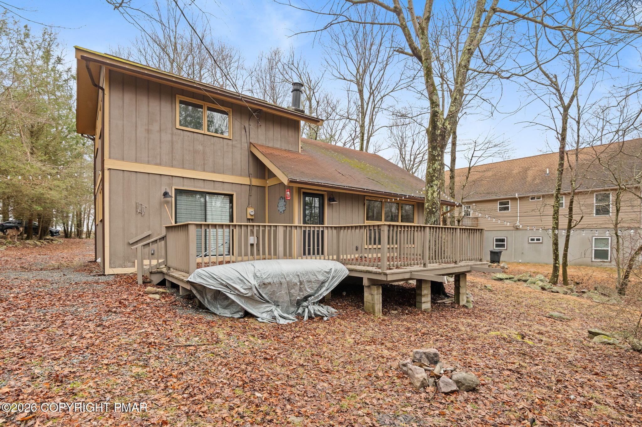 81 Split Rock Road Lake Harmony, PA 18624 - Photo 32 of 36 a backyard of a house with table and chairs