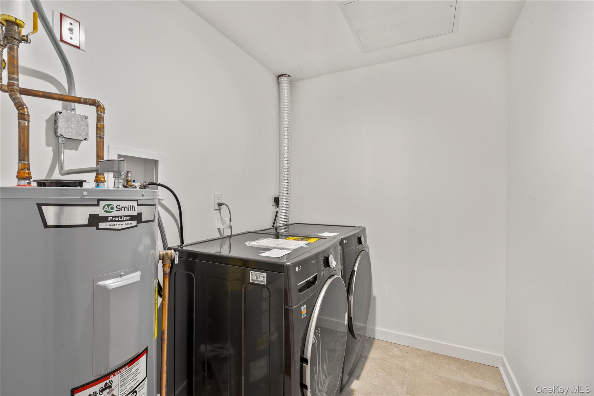 213-41 38th Avenue, Unit 2B Queens, NY 11361 - Photo 12 of 12 a utility room with dryer and washer