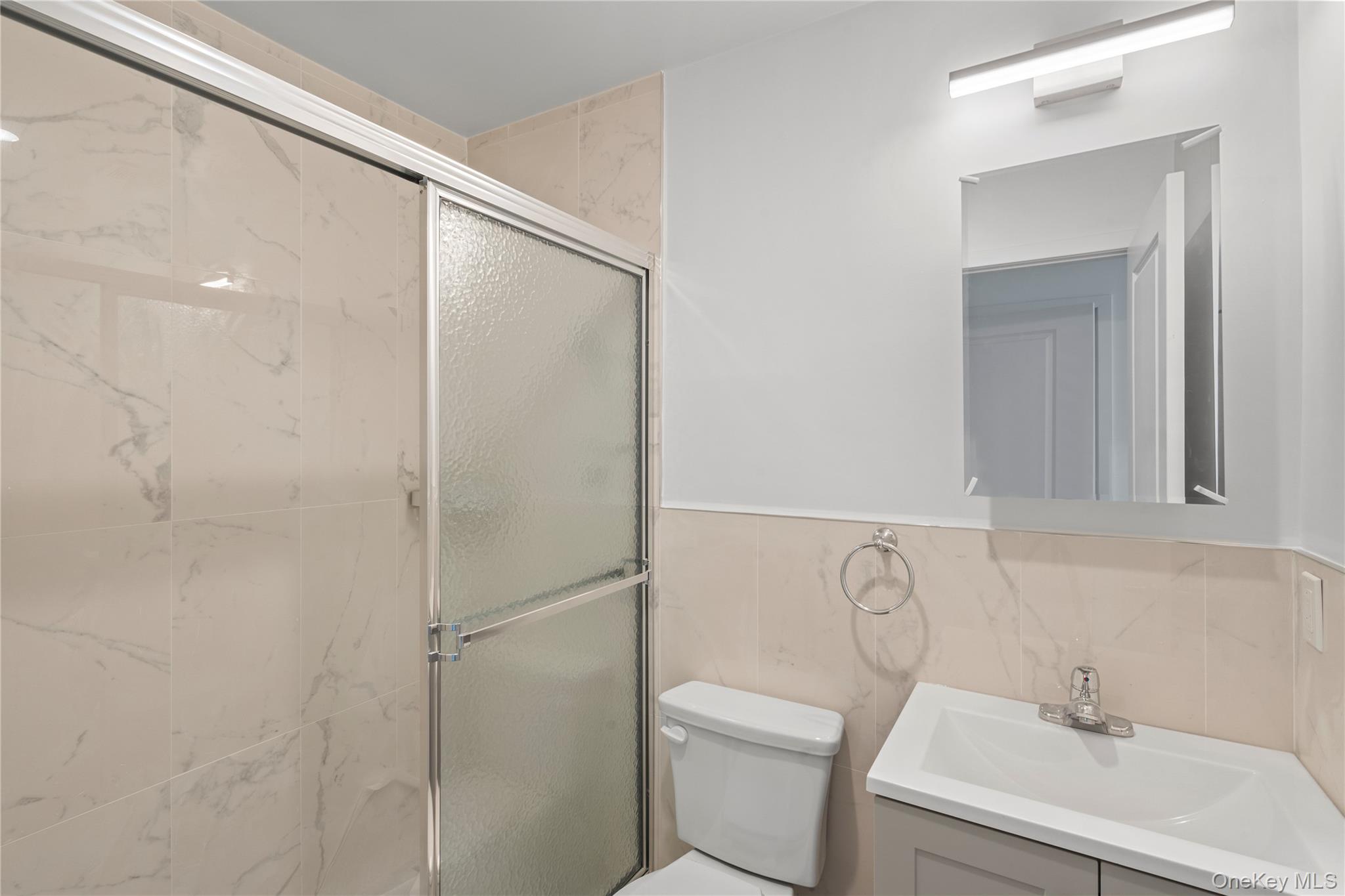 213-41 38th Avenue, Unit 2B Queens, NY 11361 - Photo 10 of 12 a bathroom with a sink toilet and shower