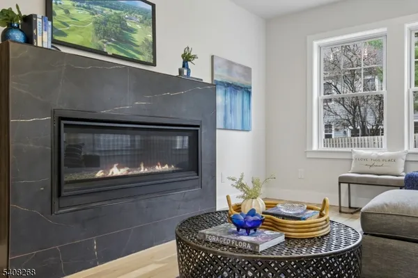 a living room with furniture a fireplace and a window