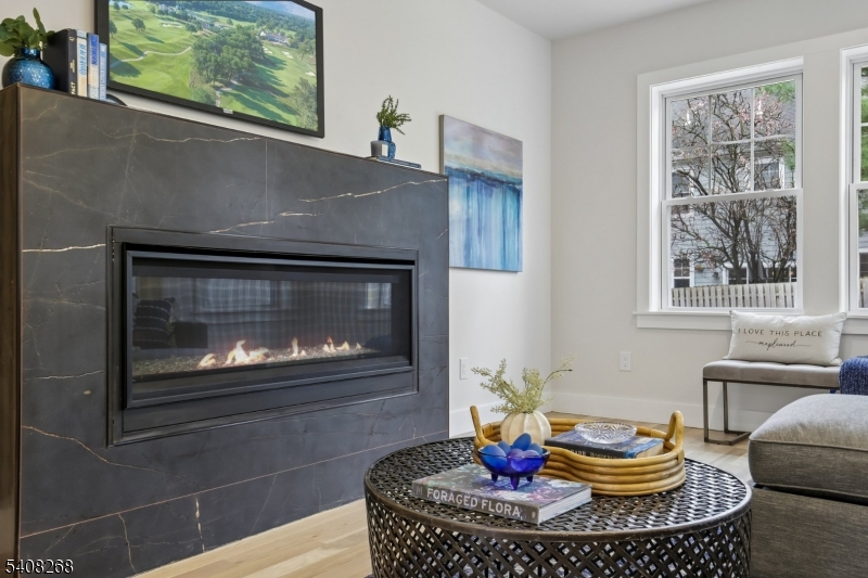 108 Baker Street Maplewood, NJ 07040 - Photo 12 of 46 a living room with furniture a fireplace and a window