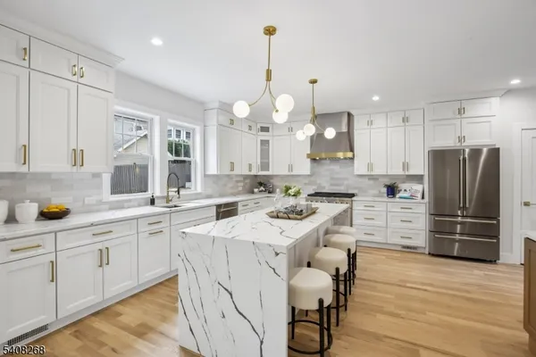 a kitchen with white cabinets and stainless steel appliances