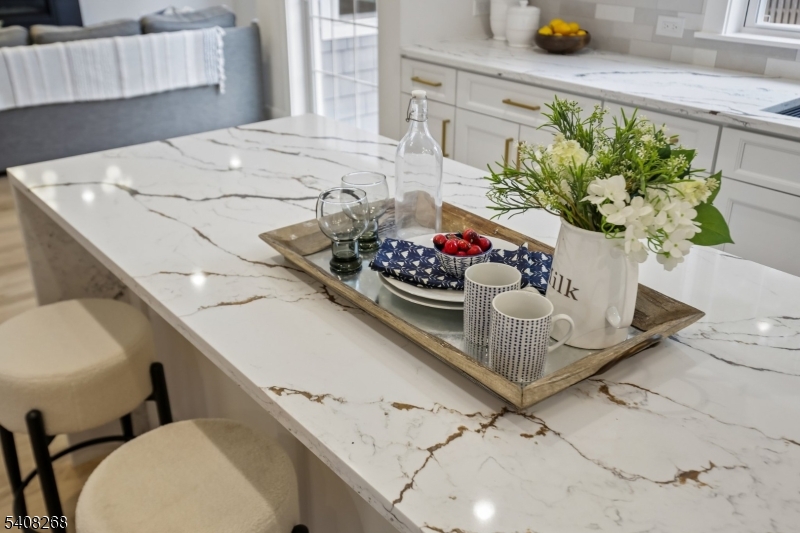 108 Baker Street Maplewood, NJ 07040 - Photo 17 of 46 a vase of flowers sitting on a floor