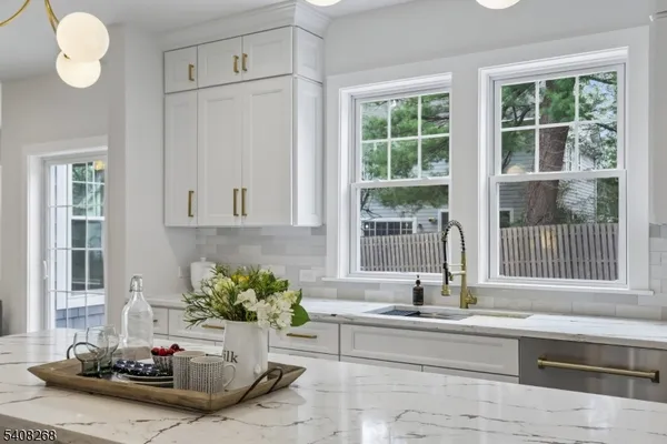 a large kitchen with a table and chairs in it