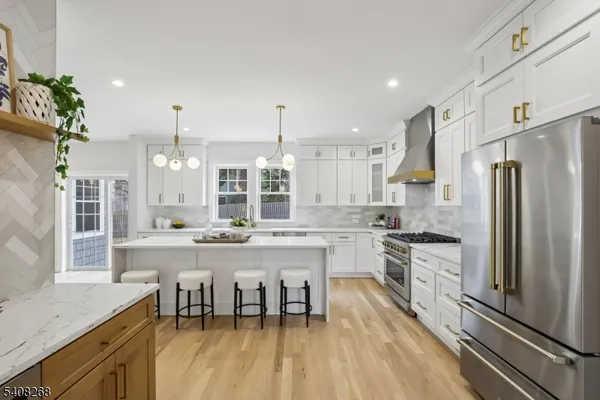 a kitchen with stainless steel appliances granite countertop a stove a sink and a refrigerator