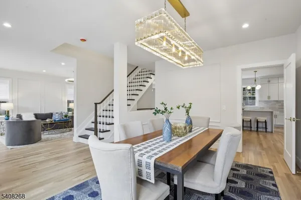 a view of a dining room with furniture wooden floor and chandelier