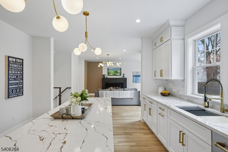 108 Baker Street Maplewood, NJ 07040 - Photo 21 of 46 a large kitchen with stainless steel appliances kitchen island granite countertop a sink and a white cabinets