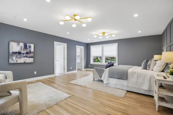 a bed room with furniture and a large window