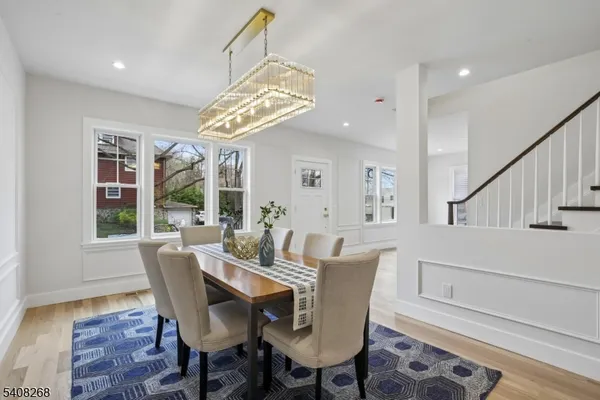 a view of a dining room with furniture wooden floor and chandelier