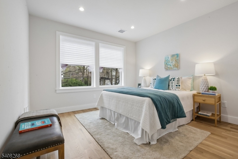 108 Baker Street Maplewood, NJ 07040 - Photo 34 of 46 a bedroom with a bed and wooden floor