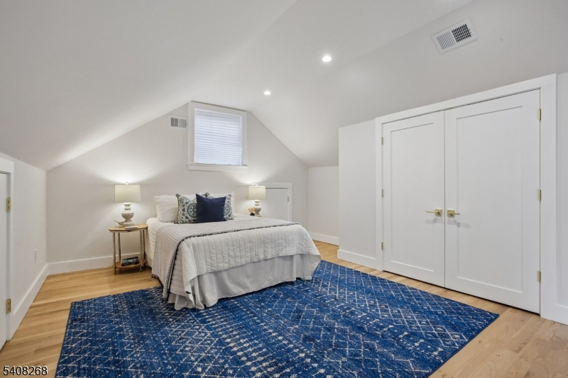 108 Baker Street Maplewood, NJ 07040 - Photo 37 of 46 a spacious bedroom with a bed and a rug