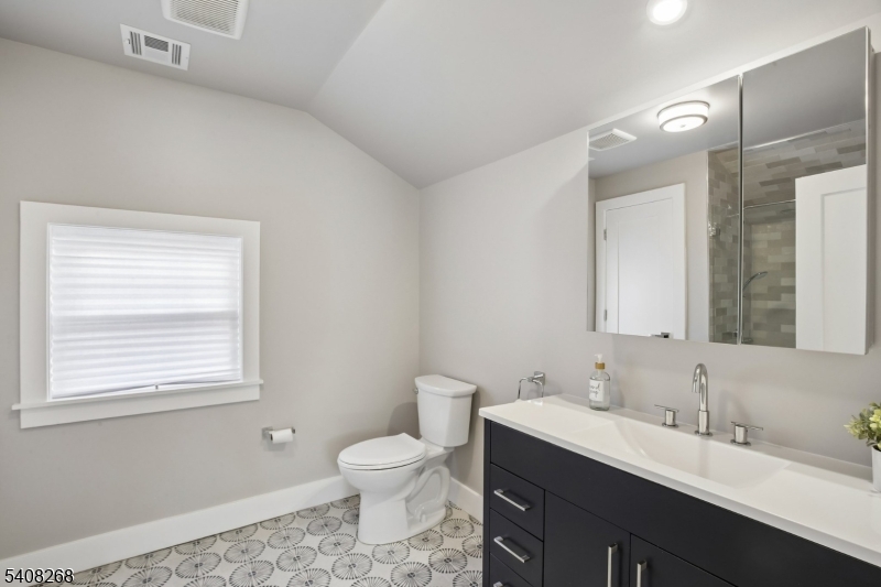 108 Baker Street Maplewood, NJ 07040 - Photo 39 of 46 a bathroom with a toilet sink and mirror