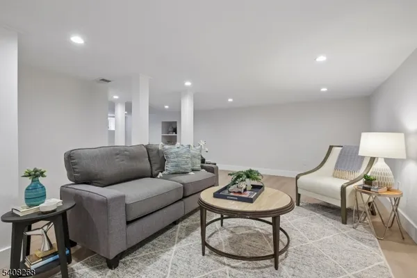 a living room with furniture and air hockey table